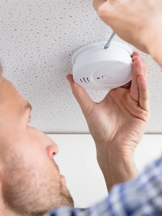 man-installing-smoke-detector